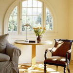 Front view of a round table between a chair and a couch